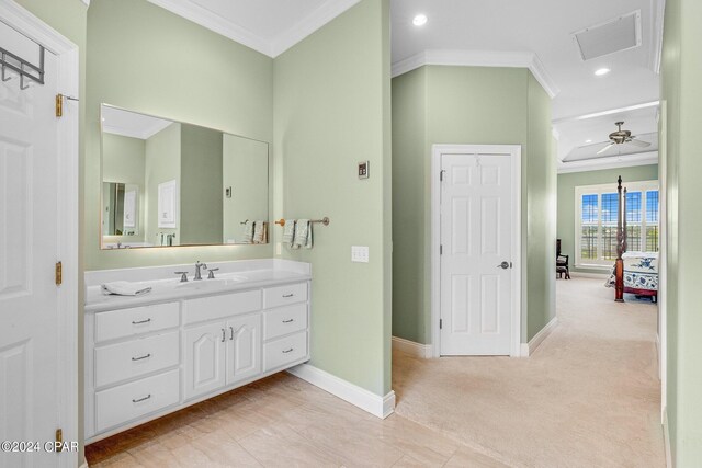 bathroom featuring crown molding, vanity, and ceiling fan