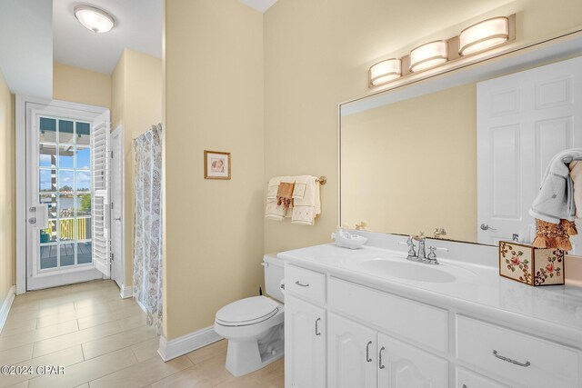 bathroom featuring vanity, toilet, and tile patterned floors