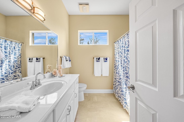 bathroom featuring vanity, toilet, and tile patterned flooring