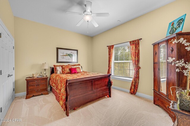 bedroom with ceiling fan and light colored carpet