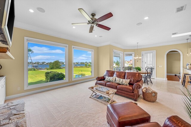 living room with ceiling fan with notable chandelier, ornamental molding, and light tile patterned floors