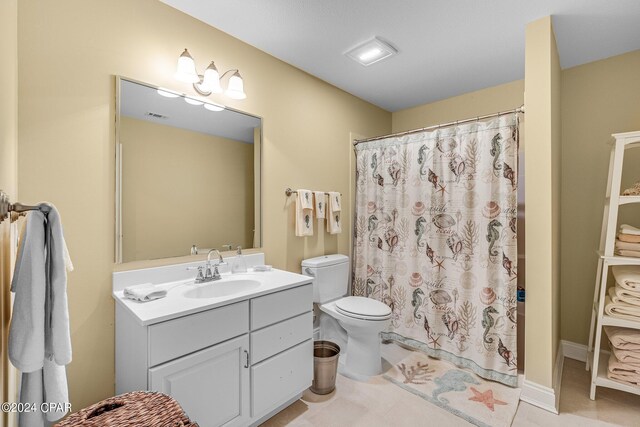 bathroom with curtained shower, tile patterned floors, toilet, and vanity