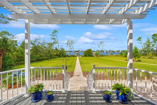 wooden deck with a lawn and a pergola