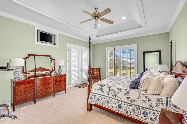 bedroom with light carpet, a tray ceiling, access to outside, crown molding, and ceiling fan