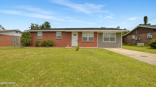 ranch-style home featuring a front lawn and central air condition unit