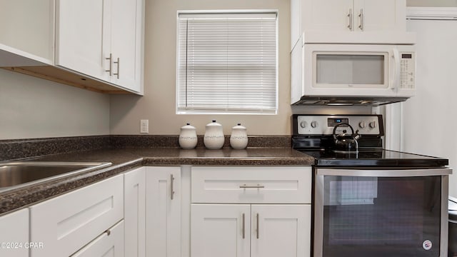 kitchen featuring white cabinetry and stainless steel range with electric cooktop