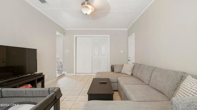 tiled living room with ornamental molding, a textured ceiling, and ceiling fan