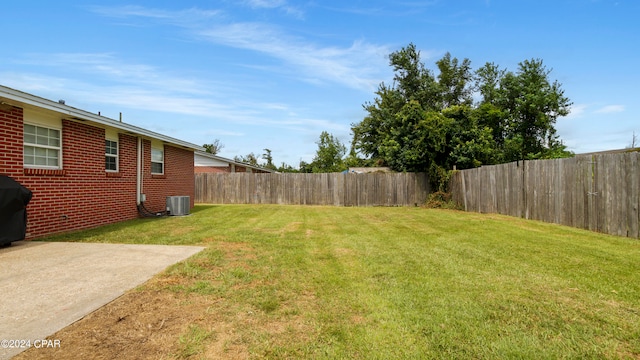 view of yard with cooling unit and a patio