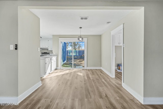 unfurnished dining area featuring light hardwood / wood-style flooring