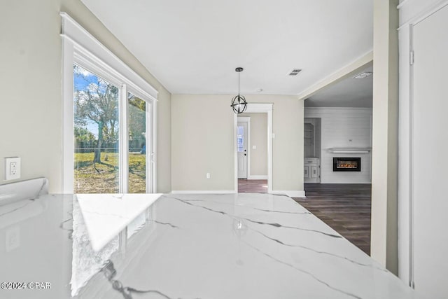 dining area with a large fireplace and dark wood-type flooring