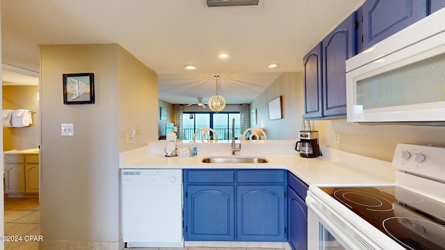 kitchen featuring blue cabinets, white appliances, sink, and hanging light fixtures