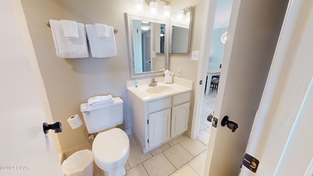 bathroom featuring tile patterned flooring, toilet, and vanity