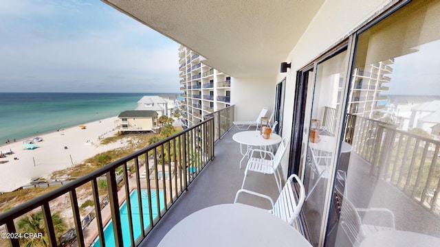 balcony with a beach view and a water view