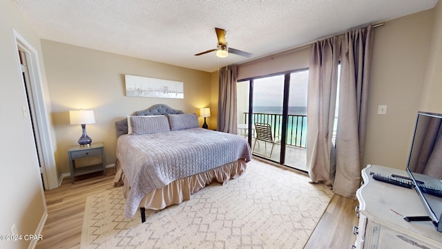 bedroom featuring a textured ceiling, access to exterior, ceiling fan, and light hardwood / wood-style floors