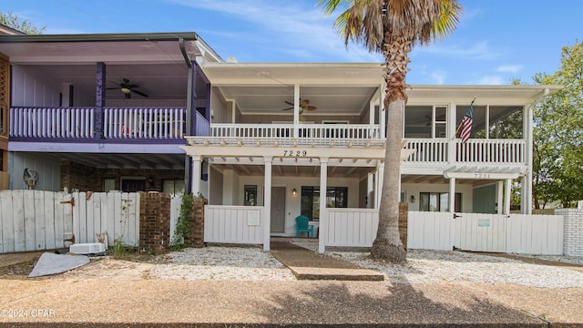 view of front of property with a balcony and ceiling fan