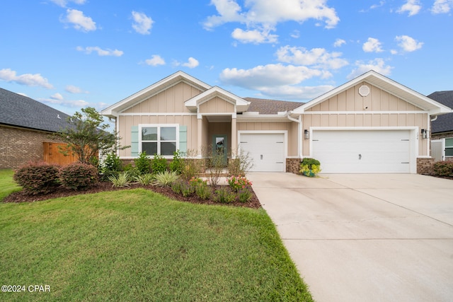 view of front of property featuring a garage and a front lawn