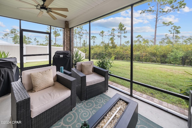 sunroom / solarium featuring ceiling fan