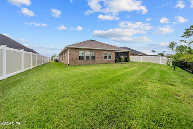 back of property featuring a yard