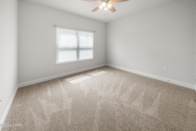 unfurnished room featuring ceiling fan and carpet