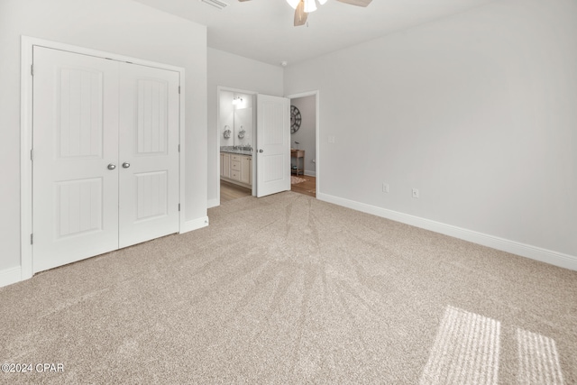 unfurnished bedroom with ceiling fan, a closet, and light carpet