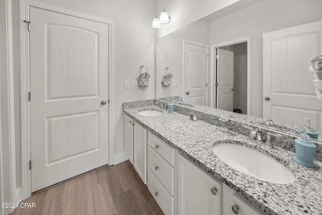 bathroom with hardwood / wood-style floors and vanity