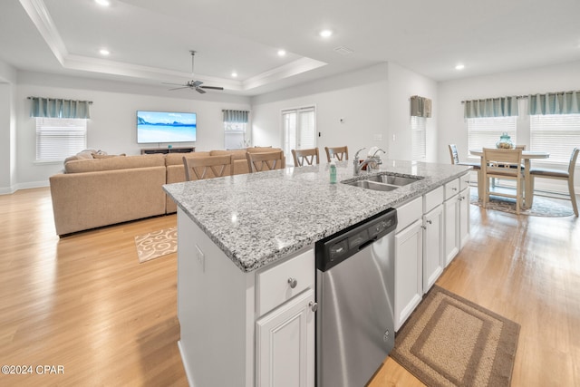 kitchen featuring a kitchen island with sink, sink, white cabinetry, a healthy amount of sunlight, and dishwasher