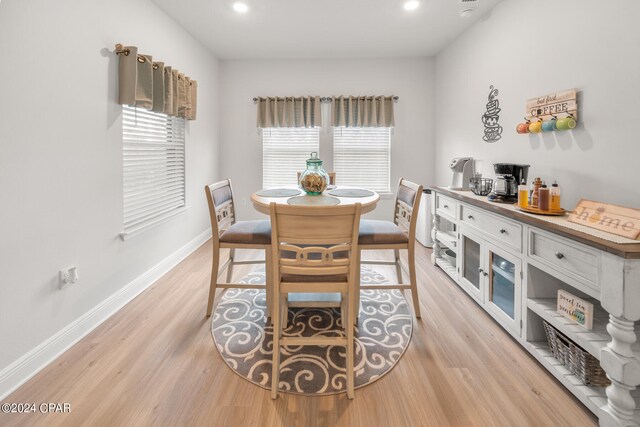 dining room with light wood-type flooring and plenty of natural light