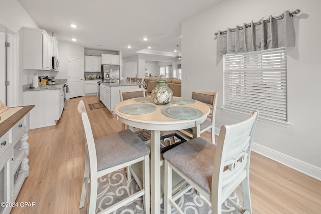 dining room featuring ceiling fan and light hardwood / wood-style floors