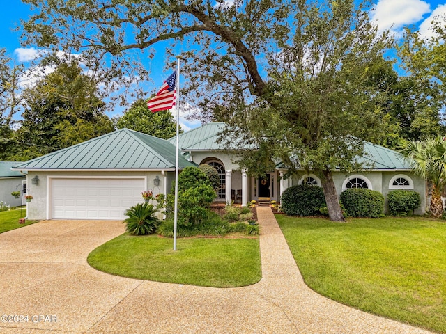 ranch-style house featuring a front yard and a garage