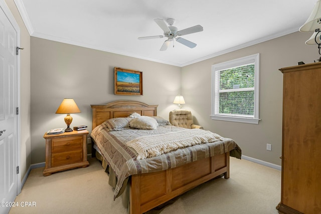 carpeted bedroom featuring crown molding and ceiling fan