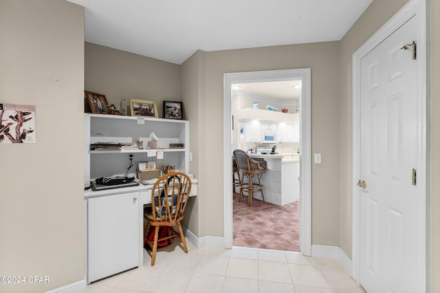 tiled home office with built in desk and crown molding