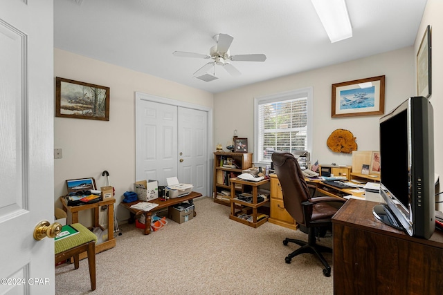 carpeted home office with ceiling fan