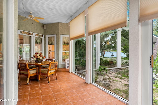 sunroom featuring ceiling fan and a wealth of natural light