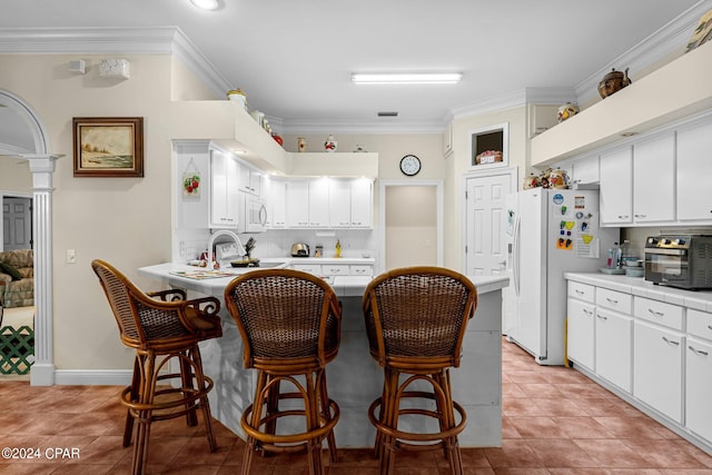 kitchen featuring white cabinets, light tile patterned flooring, sink, white appliances, and crown molding