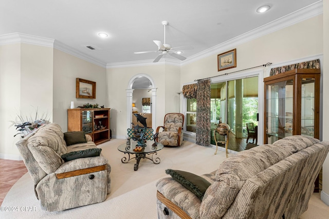 living room featuring ornamental molding, light carpet, and ceiling fan