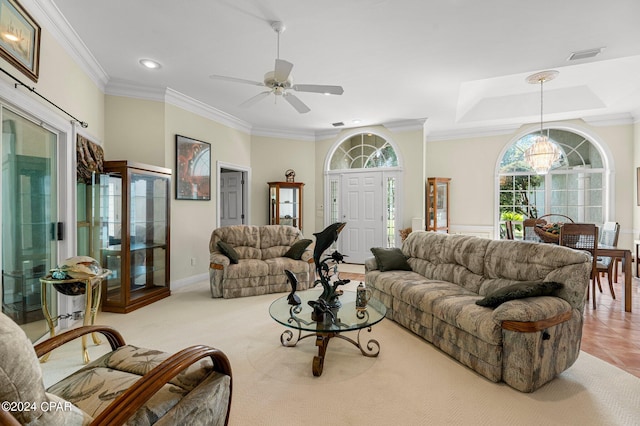 living room featuring ceiling fan with notable chandelier, ornamental molding, and light tile patterned floors