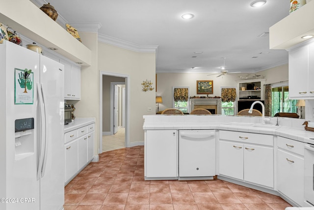 kitchen featuring ceiling fan, white cabinets, sink, white appliances, and tile countertops