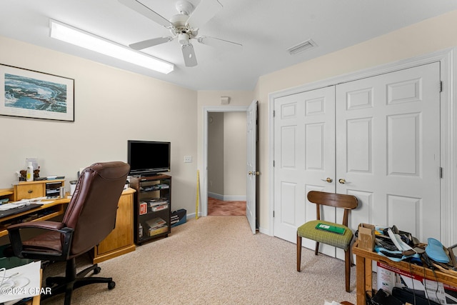 carpeted home office with ceiling fan