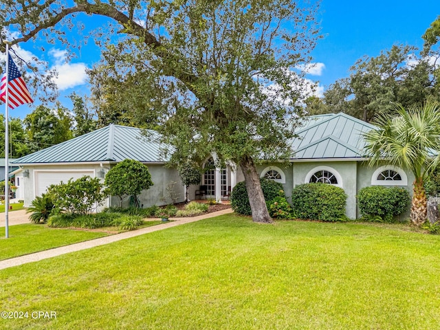 ranch-style home with a front yard and a garage