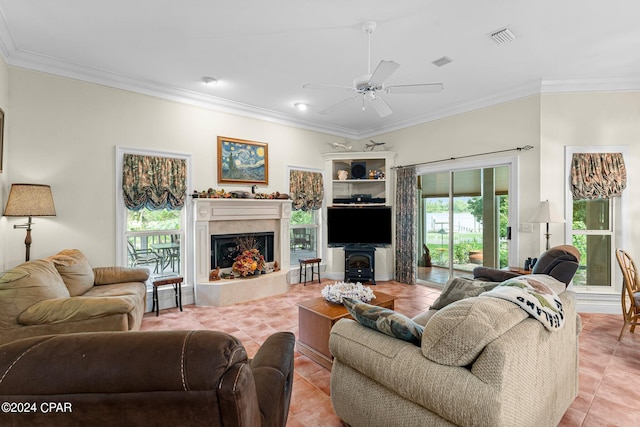 tiled living room with ornamental molding, ceiling fan, and a high end fireplace