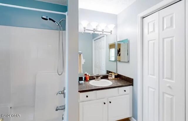 bathroom with tub / shower combination and vanity