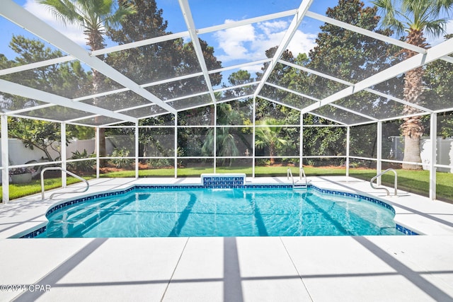 view of pool with a patio area, a lanai, and pool water feature