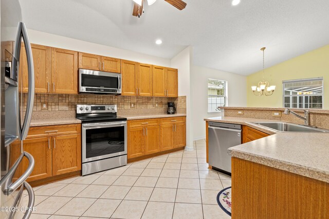 kitchen with a center island with sink, dishwasher, sink, and vaulted ceiling