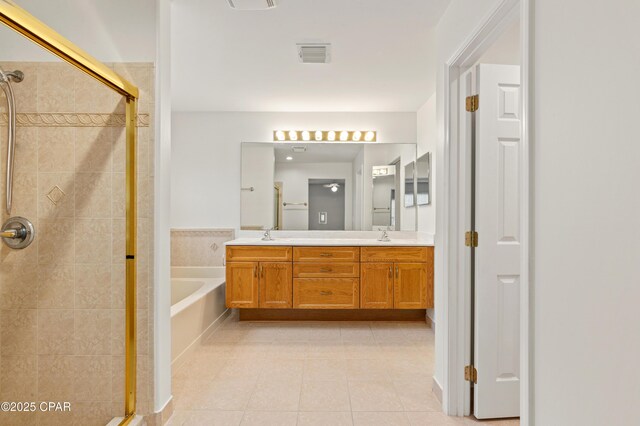 bathroom featuring tile patterned floors, separate shower and tub, and vanity