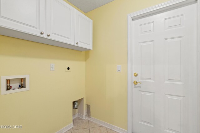 laundry area featuring light tile patterned flooring, cabinets, hookup for an electric dryer, and hookup for a washing machine