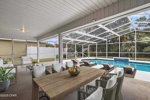 view of swimming pool featuring a patio and a lanai