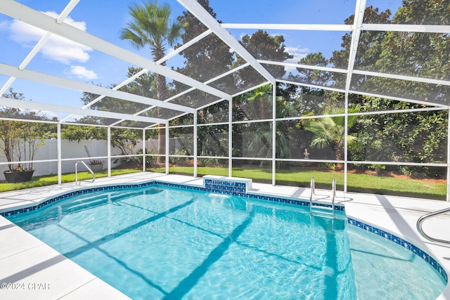 view of swimming pool with a lanai, a lawn, and a patio