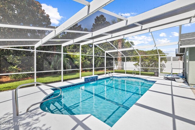 view of swimming pool featuring a patio, pool water feature, and a lanai