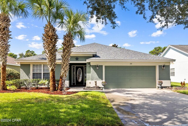 ranch-style home featuring a front yard and a garage