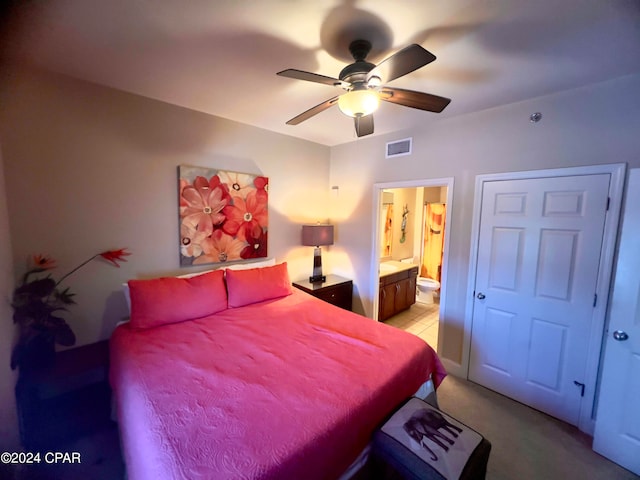 carpeted bedroom featuring ceiling fan and connected bathroom